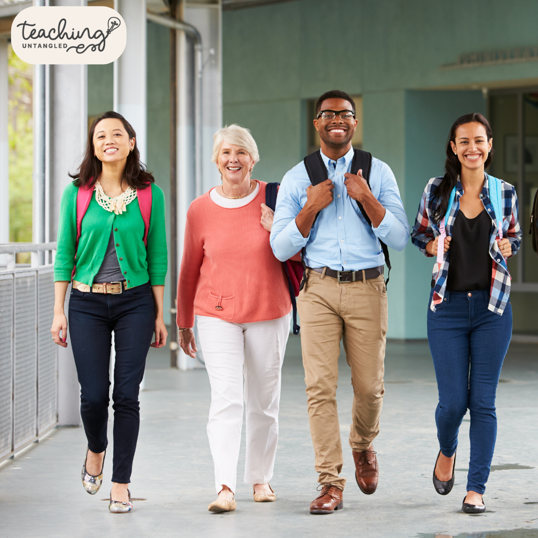 four teachers walking down the school hallway